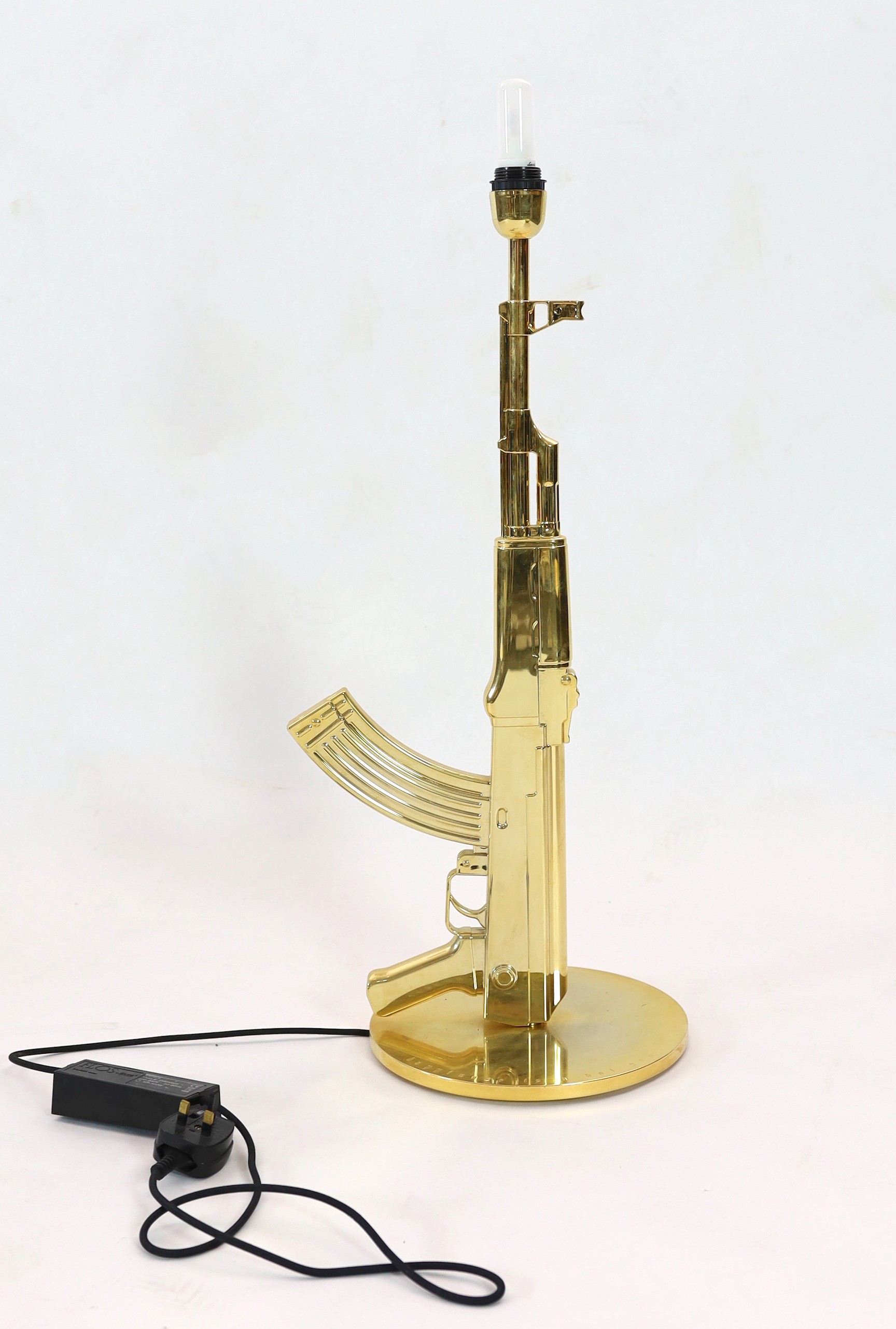 A Philippe Starck gilt metal Kalashnikov table lamp, height overall 93cm
